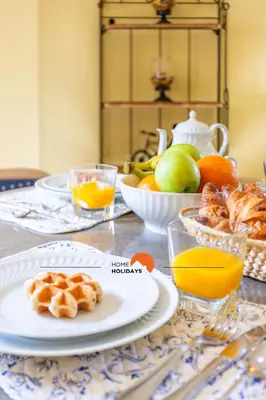 a table topped with plates of food and fruit at #214 Vivenda 3 Quartos by Home Holidays in Albufeira