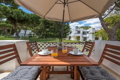 a view of a golf course with a tree at Albufeira Balaia Golf Vilage 5 With Pool by Homing in Albufeira