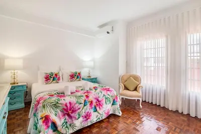 a bathroom with two sinks and a tub and a shower at Sunshine House in Faro