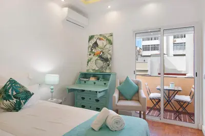 a white bedroom with a large bed and a television at Luxury Home Sweet Home T3 in Faro
