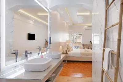 a white bathroom with two sinks and a bedroom at Luxury Home Sweet Home T3 in Faro