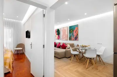 a white bedroom with a bed and a lamp at Luxury Sweet Homes T2 in Faro