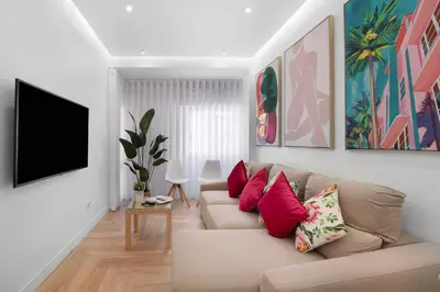a living room with a couch and a tv at Luxury Sweet Homes T2 in Faro