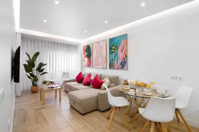 a living room with a couch and a tv at Luxury Sweet Homes T2 in Faro