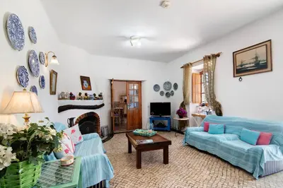 a living room with blue couches and a fireplace at Country House Casa Da Avó in Loulé