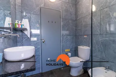 a bathroom with a toilet and a sink with the words home holidays at #268 Marvellous Villa Sapphire in Albufeira