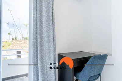 a room with a table and a chair and a window at #268 Marvellous Villa Sapphire in Albufeira