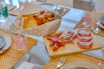 a table with a plate of food and a basket of food at Downtown Bingo Apartment in Faro