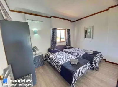 a bedroom with two beds and a window at Double ROOFTop Mont-Blanc : vue plage amazing in Albufeira