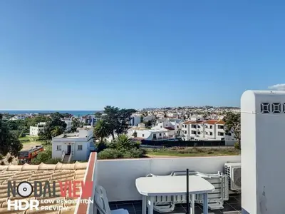 a balcony with a table and a view of the city at Double ROOFTop Mont-Blanc : vue plage amazing in Albufeira