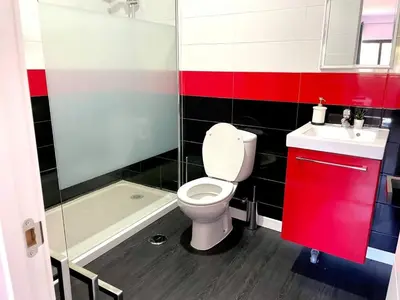 a bathroom with a toilet and a sink and a red cabinet at V8 Praia da Falésia, Albufeira in Olhos de Água