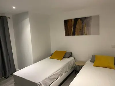 two beds in a bedroom with a painting on the wall at V8 Praia da Falésia, Albufeira in Olhos de Água