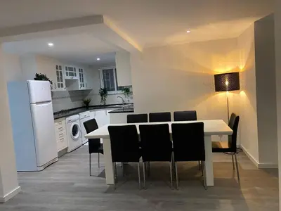 a kitchen with a table and chairs and a white refrigerator at V8 Praia da Falésia, Albufeira in Olhos de Água