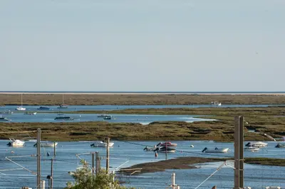 a group of boats in a body of water at Faro Heart Suites in Faro