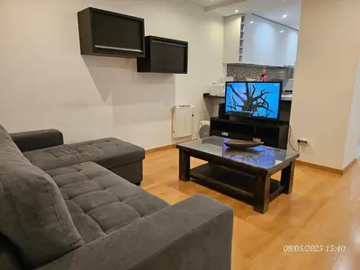 a living room with a couch and a tv at Blife Joanya private apartment in Faro