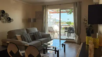 a living room with a couch and a glass table at Vista Marina Exclusiva T1 HsR Vilamarina in Quarteira
