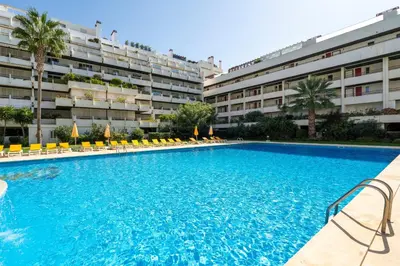 a large swimming pool in front of a building at Vista Marina Exclusiva T1 HsR Vilamarina in Quarteira