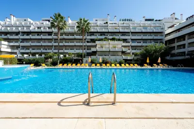 a large swimming pool in front of a building at Penthouse Triplex Marina T2 by HsR Vilamarina in Quarteira