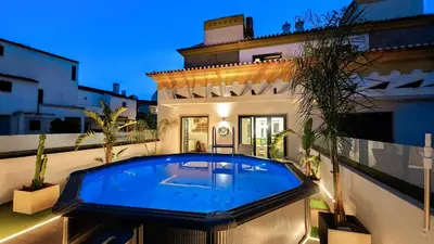 a swimming pool in the backyard of a house at Lotus by Check-in Portugal in Quarteira