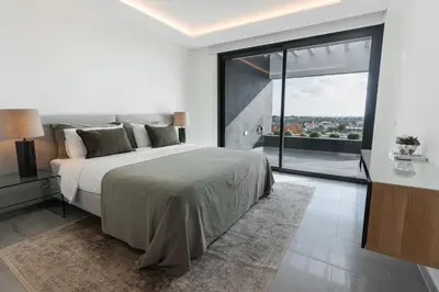 a bedroom with a large bed and a large window at Buganvilia - Luxury villa - private pool by HD in Vale Formoso