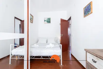a small bedroom with a bed and a mirror at #217 Dom Afonso III by Home Holidays in Albufeira