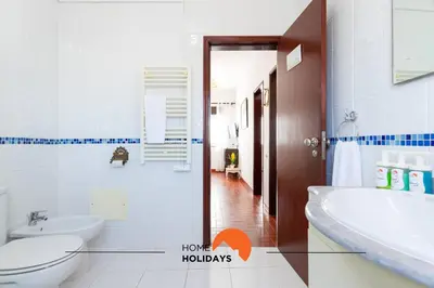 a bathroom with a toilet and a sink and a mirror at #217 Dom Afonso III by Home Holidays in Albufeira