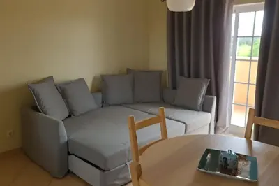 a living room with a couch and a table at Stela ' s Guest House in Loulé