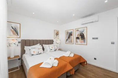a bedroom with a bed with towels on it at Terracos de Quarteira Blue by Real Properties in Quarteira