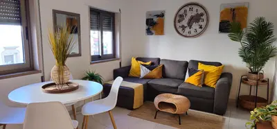 a living room with a couch and a table at Casa dos Sinos 2Bedroom Beach Apartment with Terrace in Albufeira