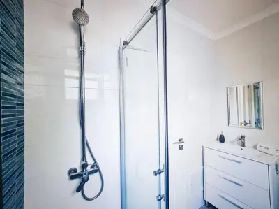 a shower stall in a bathroom with a sink at Casa dos Sinos 2Bedroom Beach Apartment with Terrace in Albufeira