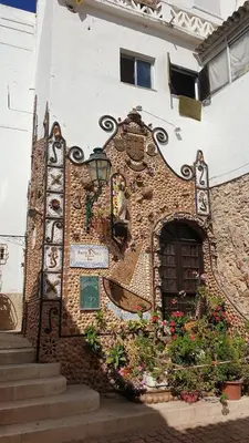 a building with a door and flowers on it at Casa dos Sinos 2Bedroom Beach Apartment with Terrace in Albufeira