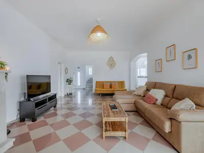 a living room with a couch and a tv at Villa Villa dos Sonhos V3 Lucia-VIP Properties by Interhome in Galé