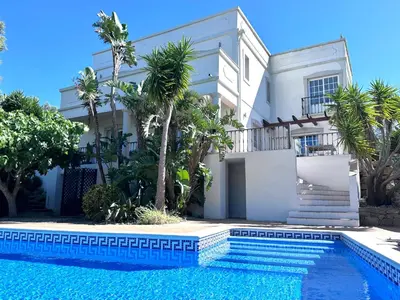 a villa with a swimming pool in front of a house at Algarve country villa near Loulé, stunning views in Romão