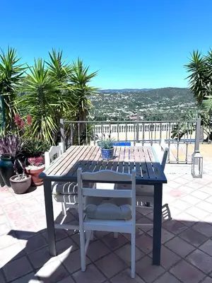 a table and chairs on a patio with a view at Algarve country villa near Loulé, stunning views in Romão