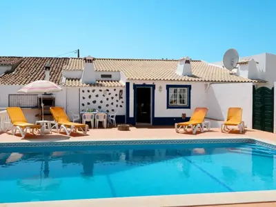 a villa with a swimming pool in front of a house at Holiday Home Monte da Calma by Interhome in Albufeira