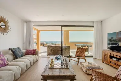 a living room with a couch and chessboard on a table at Villa Oceânica in Albufeira