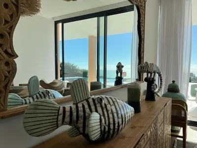 a living room with a large mirror and a couch at Villa Oceânica in Albufeira