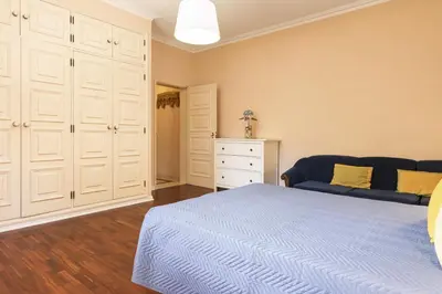 a bedroom with a blue bed and a white dresser at Vila Norte - Private Pool by HD PROPERTIES in Vilamoura