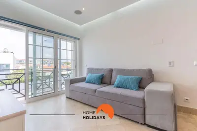 a living room with a couch and a balcony at #228 Garrett Flats by Home Holidays in Albufeira