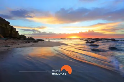 a picture of a beach with a sunset at #228 Garrett Flats by Home Holidays in Albufeira