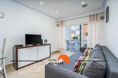 a living room with a couch and a tv at #228 Garrett Flats by Home Holidays in Albufeira