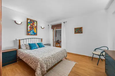 a bedroom with a bed with blue pillows on it at Helena's House Sea View in Albufeira