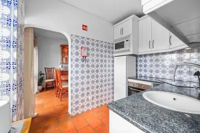 a kitchen with a sink and a counter top at Helena's House Sea View in Albufeira