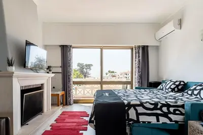 a bedroom with a bed and a fireplace and a television at OURA WHITE VIEW Beach 2 min walk sea in Albufeira