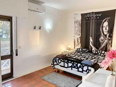 a bedroom with a poster of a woman on the wall at OURA WHITE VIEW Beach 2 min walk sea in Albufeira