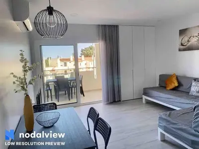 a living room with a couch and a table at ELdorado JArdim open view beach 5 minutes foot in Albufeira