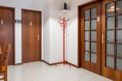 a hallway with two wooden doors and a floor at Blife Ricardya private rooms in Faro