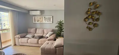 a living room with a couch and a table at Faro Main Avenue Apartment II in Faro