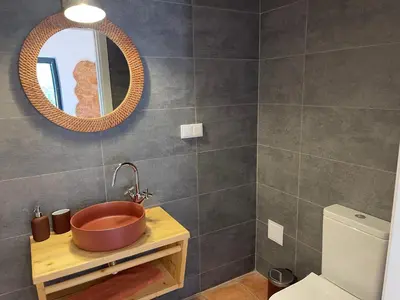 a bathroom with a copper sink and a mirror at Monte Gerações - Heated pool - Typical Algarvian - close to Quinta Lago, Vale Lobo and Vilamoura in Almancil