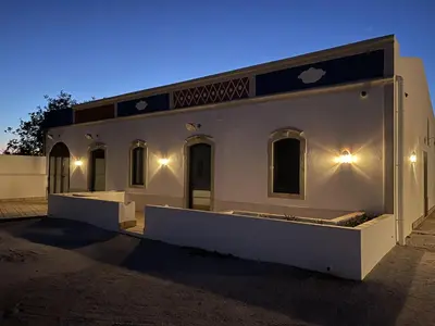 a white house with lights on the side of it at Monte Gerações - Heated pool - Typical Algarvian - close to Quinta Lago, Vale Lobo and Vilamoura in Almancil